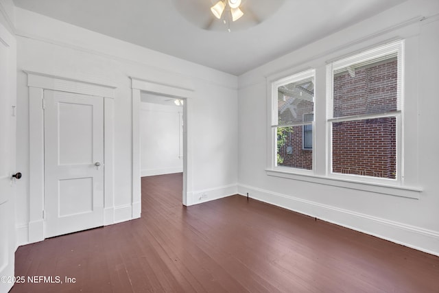 spare room featuring dark hardwood / wood-style floors and ceiling fan