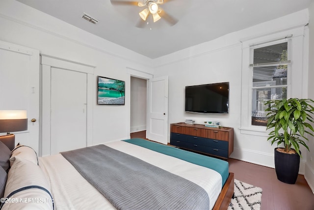 bedroom with ceiling fan and dark hardwood / wood-style flooring