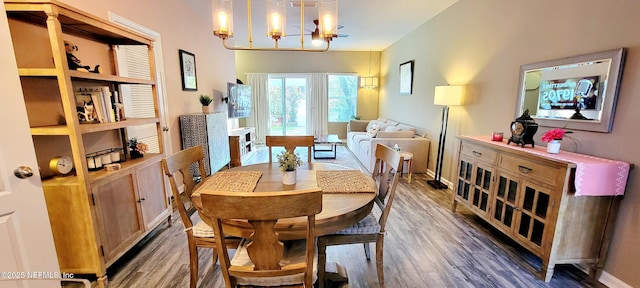 dining space featuring hardwood / wood-style flooring and a notable chandelier