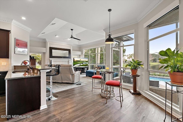 sunroom / solarium with sink and ceiling fan