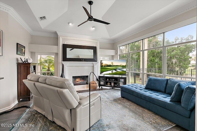 living room with high vaulted ceiling, ceiling fan, dark hardwood / wood-style floors, and a tiled fireplace