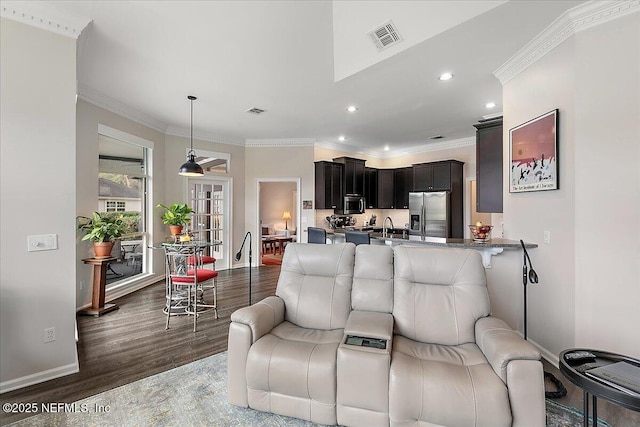 living room with crown molding, sink, and dark hardwood / wood-style flooring