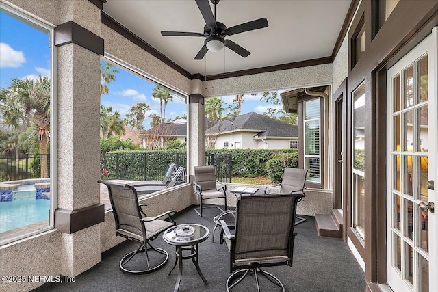 sunroom featuring ceiling fan