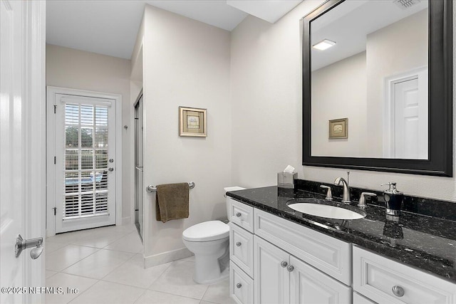 bathroom with toilet, tile patterned flooring, and vanity