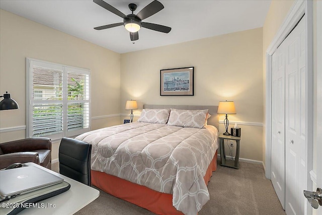 carpeted bedroom featuring ceiling fan and a closet