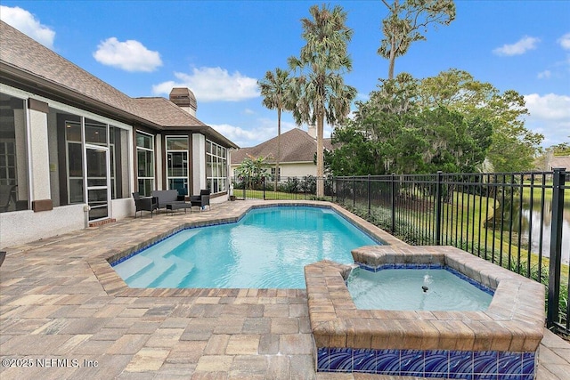 view of pool featuring a patio, an in ground hot tub, and a water view