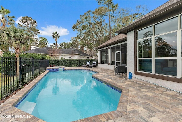 view of swimming pool with an in ground hot tub, a sunroom, and a patio