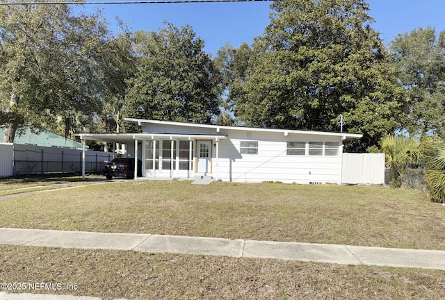 view of front facade featuring a front lawn and a carport