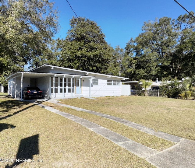 ranch-style house featuring a front yard and a carport