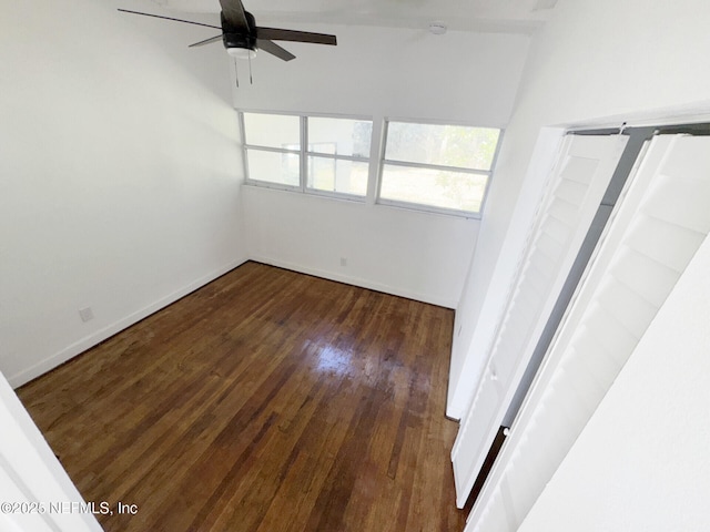 empty room featuring ceiling fan and dark hardwood / wood-style floors