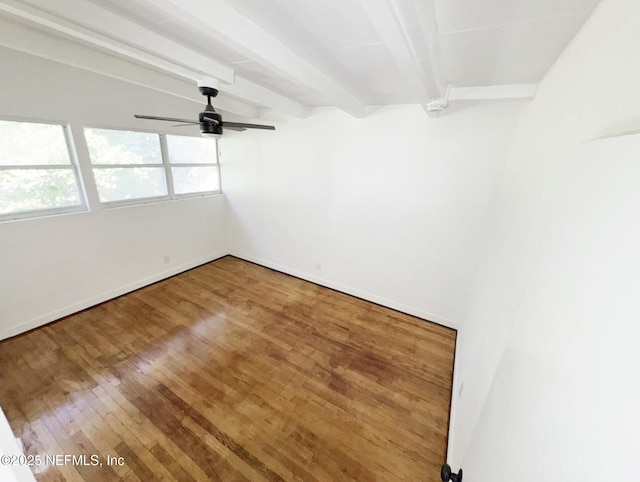 spare room featuring ceiling fan, beam ceiling, and hardwood / wood-style floors