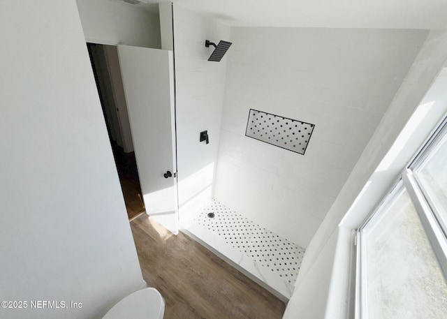 bathroom featuring wood-type flooring, toilet, and walk in shower