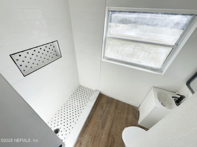 bathroom with a shower, wood-type flooring, and toilet