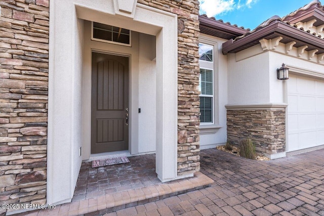 entrance to property featuring a garage