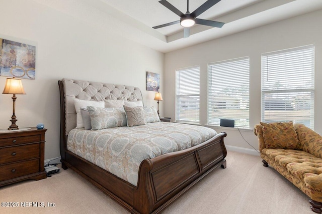 bedroom featuring ceiling fan, light carpet, and multiple windows