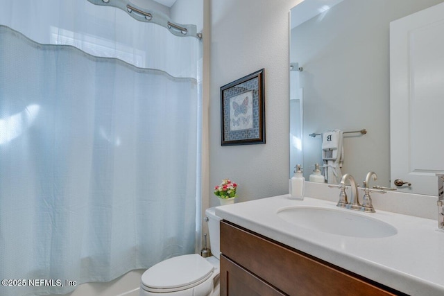 full bathroom featuring vanity, shower / bath combination with curtain, and toilet