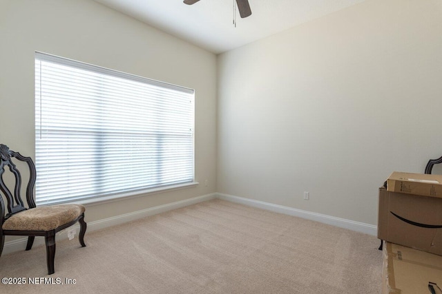 sitting room with ceiling fan, light carpet, and a wealth of natural light