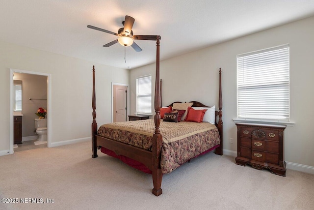 bedroom featuring connected bathroom, light colored carpet, and ceiling fan