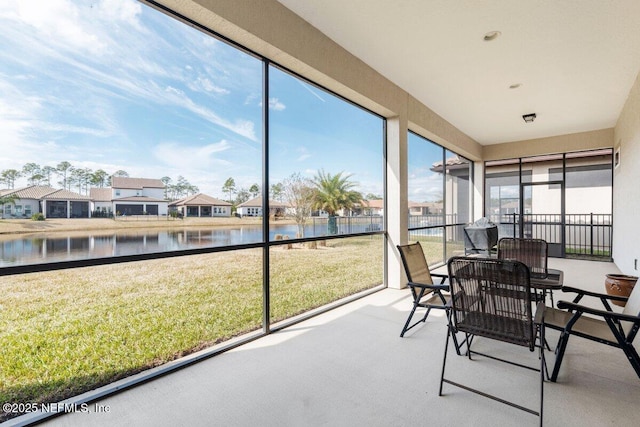 sunroom / solarium with a water view