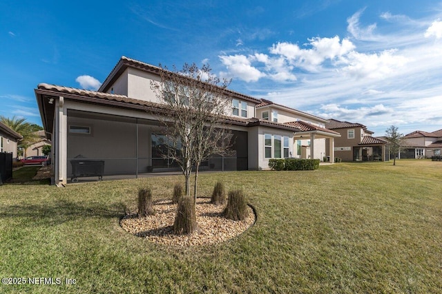 rear view of property featuring a lawn