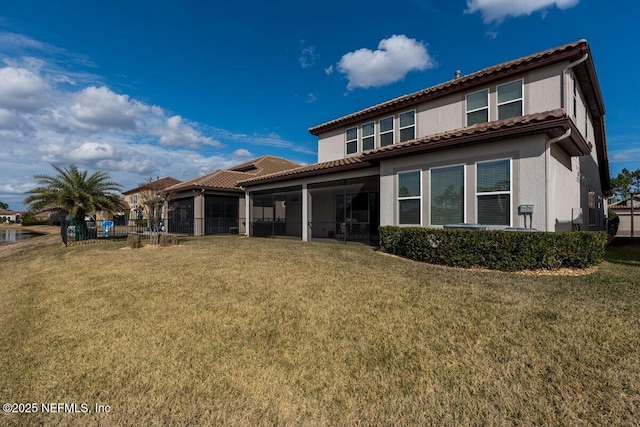 rear view of house featuring a yard