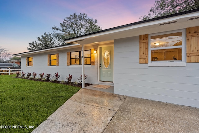 single story home with a lawn