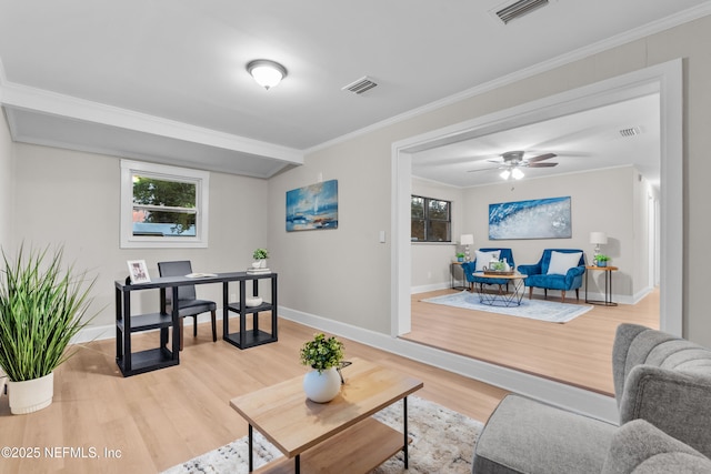 living room featuring hardwood / wood-style flooring, ceiling fan, and ornamental molding