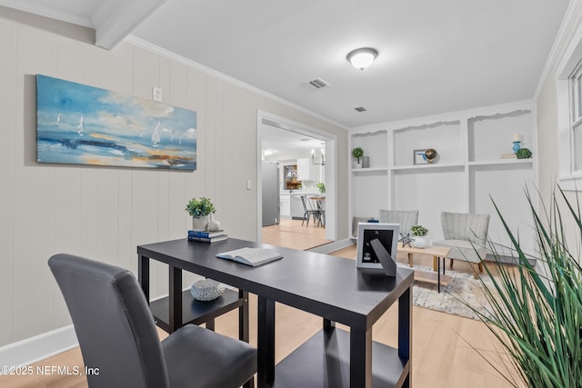 dining room with built in features, light hardwood / wood-style floors, beam ceiling, and ornamental molding