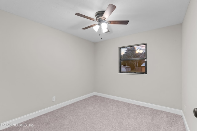 empty room with ceiling fan and carpet flooring