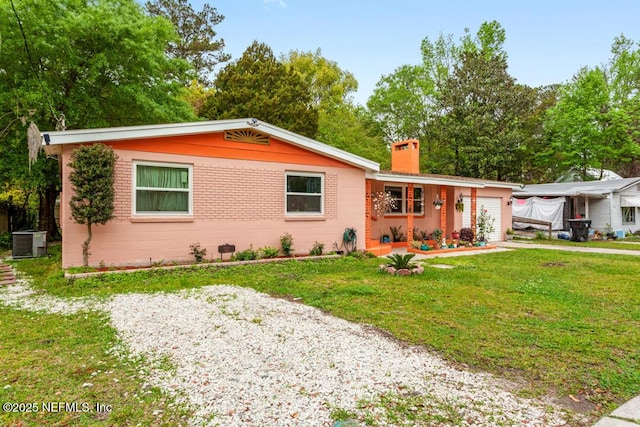 ranch-style house featuring a front yard and central air condition unit