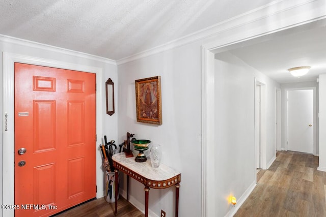 foyer with ornamental molding, a textured ceiling, and wood-type flooring