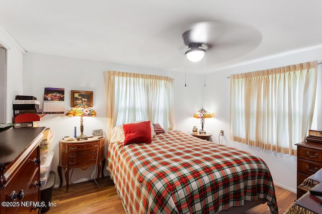 bedroom with ceiling fan and light hardwood / wood-style flooring