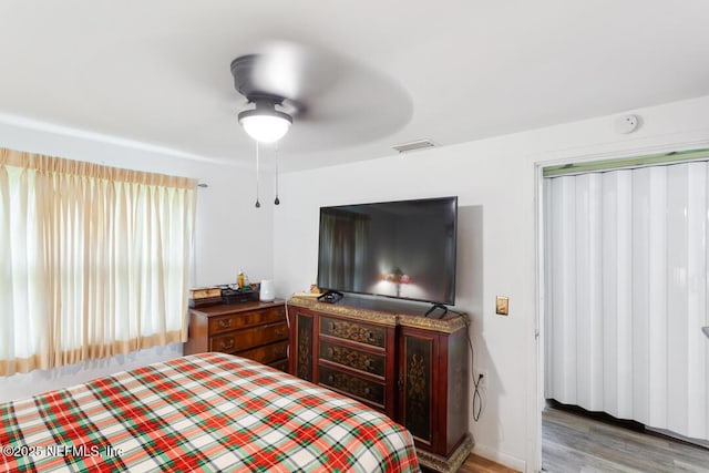 bedroom with hardwood / wood-style flooring and ceiling fan