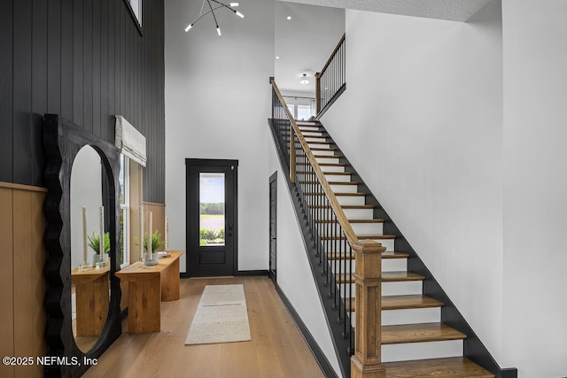 entrance foyer with a high ceiling and hardwood / wood-style floors