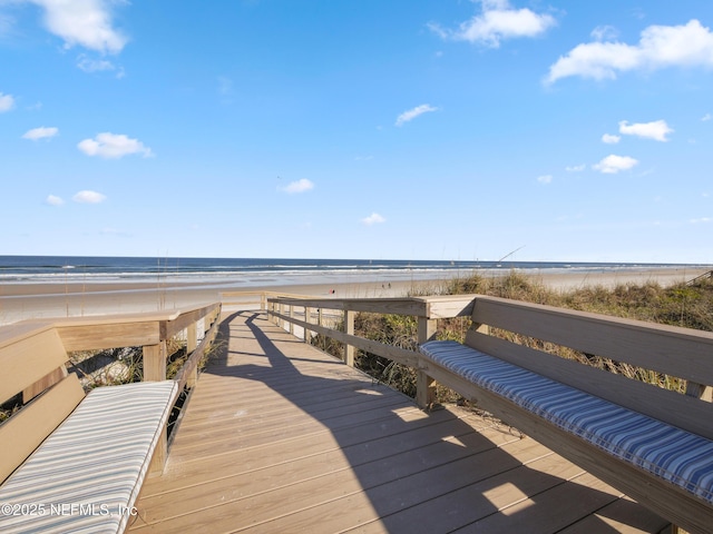 view of home's community featuring a water view and a view of the beach