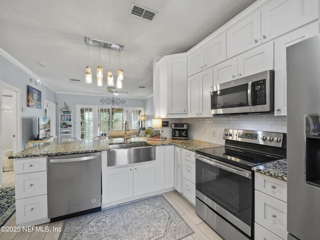 kitchen featuring kitchen peninsula, sink, white cabinets, and appliances with stainless steel finishes