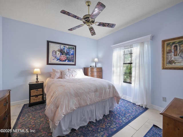 tiled bedroom with a textured ceiling and ceiling fan