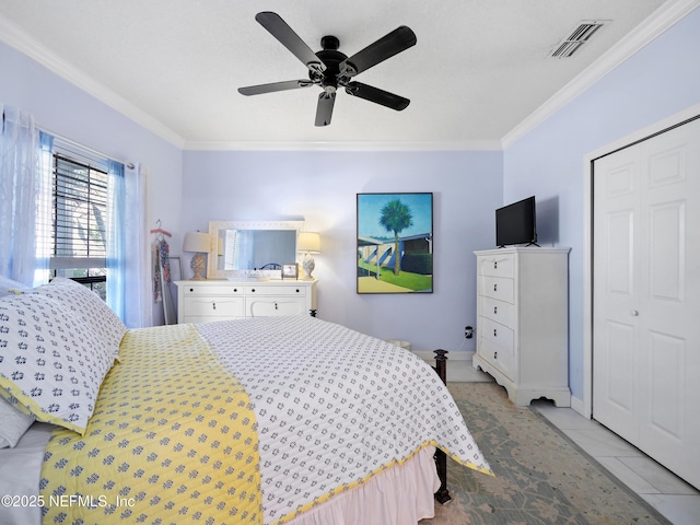 bedroom featuring ceiling fan, a closet, ornamental molding, and light tile patterned flooring