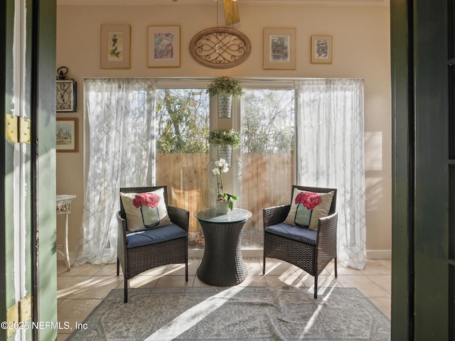 living area with light tile patterned floors and ceiling fan