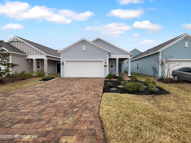 view of front of home with a garage and a front yard