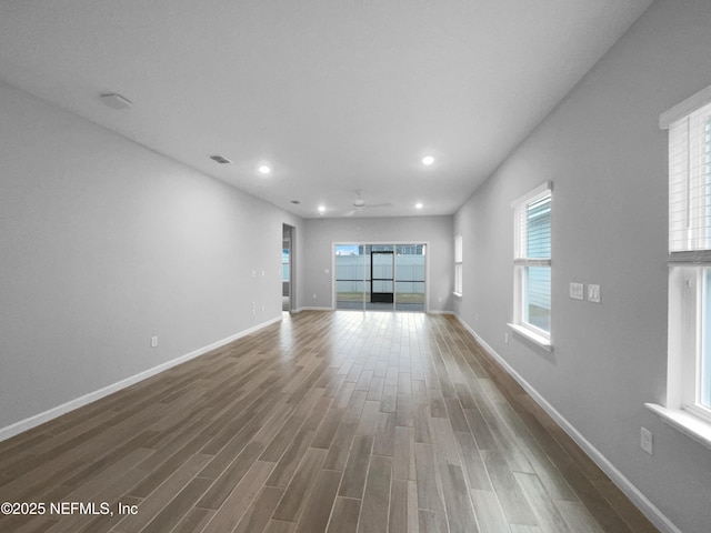 unfurnished living room featuring hardwood / wood-style flooring