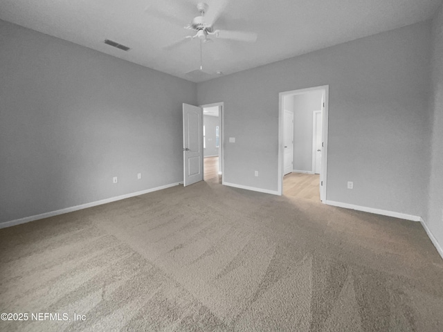 carpeted spare room featuring ceiling fan