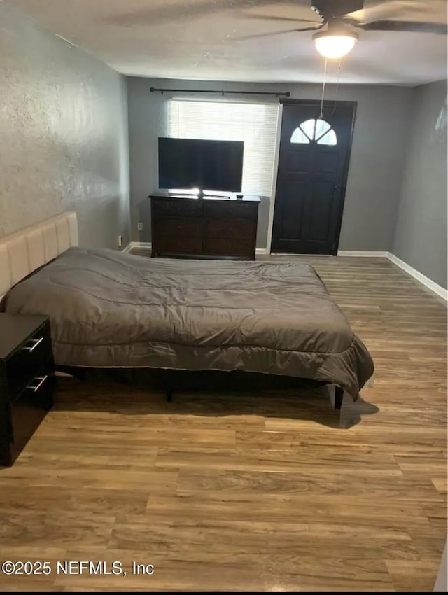 bedroom featuring hardwood / wood-style floors and ceiling fan