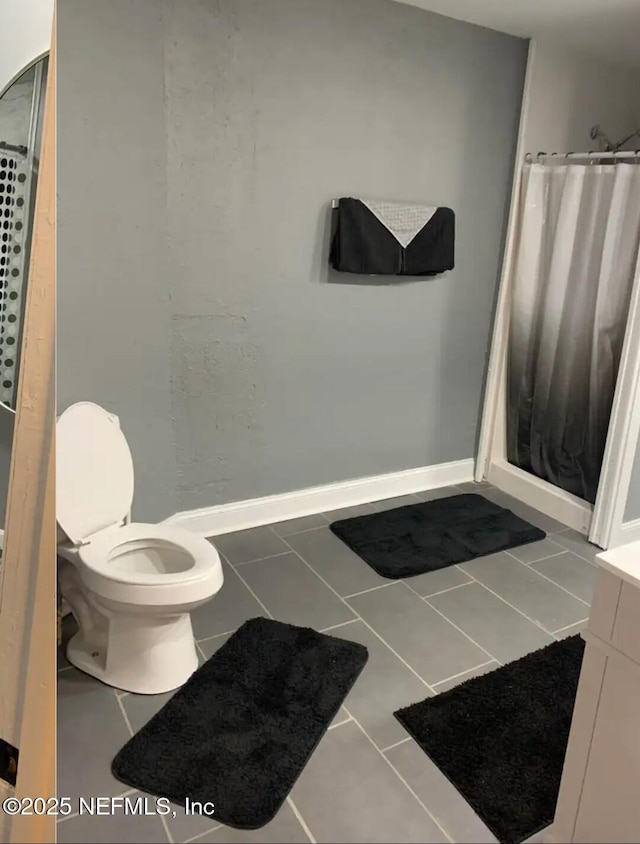 bathroom with tile patterned floors, toilet, a shower with shower curtain, and vanity