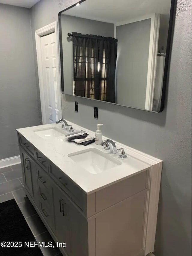 bathroom featuring tile patterned flooring and vanity