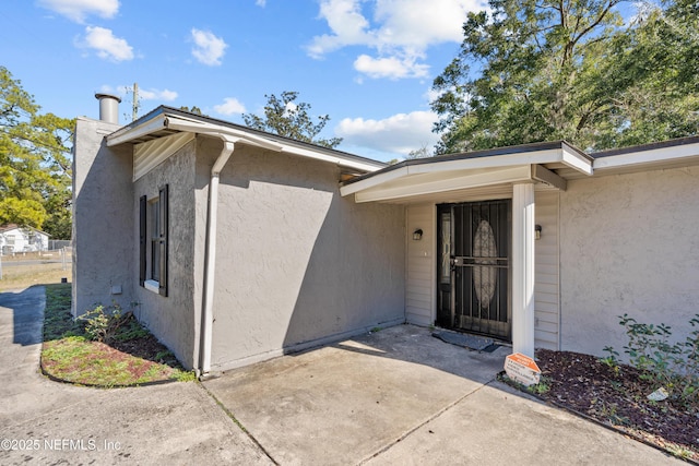 doorway to property featuring a patio