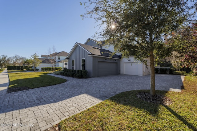 view of property exterior with a garage and a yard