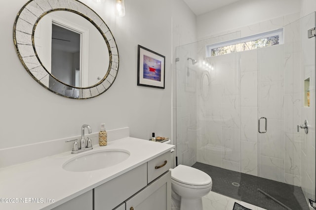 bathroom featuring toilet, vanity, and walk in shower