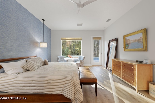 bedroom with access to exterior and light wood-type flooring