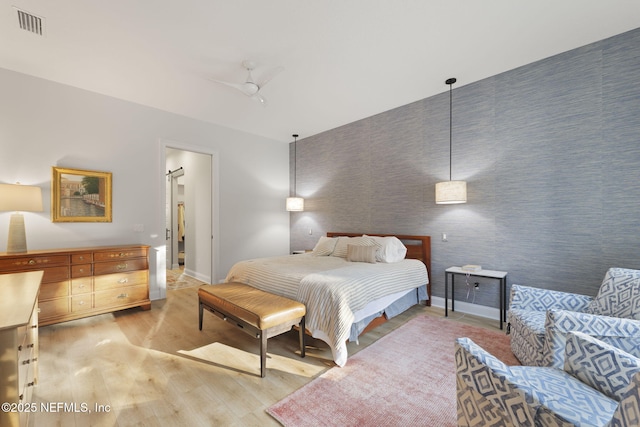 bedroom with light hardwood / wood-style floors and ceiling fan